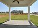 Covered patio with a concrete floor, providing a comfortable outdoor space with views of the well-maintained lawn at 102 Cartington Way # Haf0042, Mooresville, NC 28115