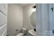 Simple powder room with a pedestal sink, mirror, and compact toilet in a neutral palette at 102 Cartington Way # Haf0042, Mooresville, NC 28115