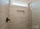A detailed shot of the shower showcasing the unique tile design and built-in niche for toiletries at 102 Cartington Way # Haf0042, Mooresville, NC 28115