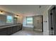 Bright bathroom featuring double vanity, soaking tub with window view, and a glass enclosed shower at 113 Tonbridge Way # Haf0031, Mooresville, NC 28115
