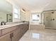 Modern bathroom featuring a double vanity, soaking tub, and a glass-enclosed shower at 113 Tonbridge Way # Haf0031, Mooresville, NC 28115