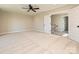 Large bedroom with carpet, ceiling fan, and an open doorway with a staircase beyond at 113 Tonbridge Way # Haf0031, Mooresville, NC 28115
