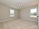 Bright bedroom with neutral walls, carpet, and natural light from two windows at 113 Tonbridge Way # Haf0031, Mooresville, NC 28115