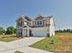 Beautiful two-story home with manicured lawn, a two-car garage, and a welcoming entrance at 113 Tonbridge Way # Haf0031, Mooresville, NC 28115