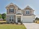 Beautiful two-story home with brick and siding, manicured lawn, and a two-car garage at 113 Tonbridge Way # Haf0031, Mooresville, NC 28115