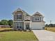 Charming two-story home with a brick and siding facade and a well-manicured lawn at 113 Tonbridge Way # Haf0031, Mooresville, NC 28115
