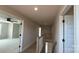 Upstairs hallway featuring a view of the landing, doors, and neutral wall paint at 113 Tonbridge Way # Haf0031, Mooresville, NC 28115
