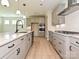 Stylish kitchen with gray cabinets, a large island, stainless steel appliances, and tile backsplash at 113 Tonbridge Way # Haf0031, Mooresville, NC 28115