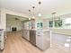 Modern kitchen showcasing stainless steel appliances, kitchen island, and open layout to dining and living areas at 113 Tonbridge Way # Haf0031, Mooresville, NC 28115
