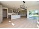 Spacious kitchen with grey cabinetry, stainless steel appliances, large island, and modern pendant lighting at 113 Tonbridge Way # Haf0031, Mooresville, NC 28115