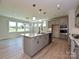 Bright kitchen featuring an island with pendant lights, stainless steel appliances, and adjacent dining area at 113 Tonbridge Way # Haf0031, Mooresville, NC 28115
