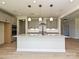 Modern kitchen with a large island, granite countertops, stainless steel appliances, and gray cabinetry at 113 Tonbridge Way # Haf0031, Mooresville, NC 28115