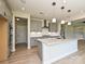 Spacious kitchen with island, stainless steel appliances, gray cabinets, and modern lighting fixtures at 113 Tonbridge Way # Haf0031, Mooresville, NC 28115