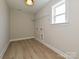 Utility room with vinyl floors, window, overhead light and washer/dryer hookups at 113 Tonbridge Way # Haf0031, Mooresville, NC 28115