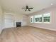 Bright living room with a fireplace and built-in shelving at 113 Tonbridge Way # Haf0031, Mooresville, NC 28115