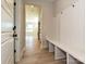 Mudroom featuring wood floors, a built-in bench with hooks, and views into the house at 113 Tonbridge Way # Haf0031, Mooresville, NC 28115