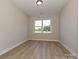 Well-lit room with neutral walls and flooring plus a window with a view at 113 Tonbridge Way # Haf0031, Mooresville, NC 28115