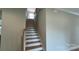 A bright stairway with hardwood steps and white risers leads to the upper level at 113 Tonbridge Way # Haf0031, Mooresville, NC 28115