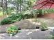 A spacious backyard featuring a wooden deck, a lush lawn, mature trees, and partial shade perfect for outdoor enjoyment at 11421 Kingfisher Dr, Charlotte, NC 28226
