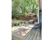 The backyard features a spacious wooden deck with comfortable seating and a shaded patio area for relaxing outdoors at 11421 Kingfisher Dr, Charlotte, NC 28226