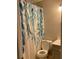 Neutral bathroom featuring a toilet, vanity, and a floral-patterned shower curtain at 11421 Kingfisher Dr, Charlotte, NC 28226