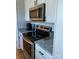 Modern kitchen featuring stainless steel appliances, granite countertops, and white cabinetry for a clean and sleek look at 11421 Kingfisher Dr, Charlotte, NC 28226