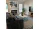 Inviting living room with a cozy fireplace, stylish decor, and a large window offering ample natural light at 11421 Kingfisher Dr, Charlotte, NC 28226