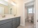 Stylish bathroom featuring double vanity with gray cabinets and modern fixtures, with view to shower at 119 Tonbridge Way # Haf0033, Mooresville, NC 28115