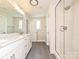 Bathroom with double sink vanity and white tiled glass shower at 119 Tonbridge Way # Haf0033, Mooresville, NC 28115