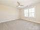 Neutral bedroom with soft carpet, ceiling fan, and a large window offering abundant natural light at 119 Tonbridge Way # Haf0033, Mooresville, NC 28115