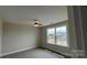 Cozy bedroom with neutral carpeting and a window showcasing a picturesque neighborhood view at 119 Tonbridge Way # Haf0033, Mooresville, NC 28115