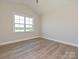 Bedroom featuring wood floors and a large window overlooking a green landscape at 119 Tonbridge Way # Haf0033, Mooresville, NC 28115
