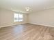 Spacious bedroom featuring neutral walls, hardwood floors, and a large window for natural light at 119 Tonbridge Way # Haf0033, Mooresville, NC 28115