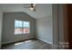 Bright bedroom with hardwood floors and a window overlooking a residential area at 119 Tonbridge Way # Haf0033, Mooresville, NC 28115
