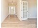 Bright foyer with wood floors, a white front door with glass panels, and an open view into the home at 119 Tonbridge Way # Haf0033, Mooresville, NC 28115