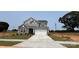 Charming two-story home with gray siding, stone accents, and a well-manicured lawn, showcasing curb appeal at 119 Tonbridge Way # Haf0033, Mooresville, NC 28115