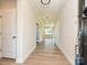 Inviting hallway with wood floors, white trim, and an open view into the home's living spaces at 119 Tonbridge Way # Haf0033, Mooresville, NC 28115