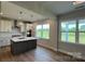 Kitchen features modern appliances, an island with sink, white cabinets, tile backsplash, and ample natural light at 119 Tonbridge Way # Haf0033, Mooresville, NC 28115