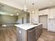 Modern kitchen features an island with a quartz countertop, stainless steel appliances, and pendant lighting at 119 Tonbridge Way # Haf0033, Mooresville, NC 28115
