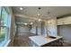 Open concept kitchen showcases a large kitchen island with pendant lighting and an adjoining living space at 119 Tonbridge Way # Haf0033, Mooresville, NC 28115