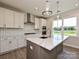 Stylish kitchen featuring white cabinets, stainless steel appliances, a center island with seating, and modern lighting at 119 Tonbridge Way # Haf0033, Mooresville, NC 28115
