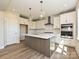 Modern kitchen with white cabinets, stainless steel appliances, a center island, and stylish pendant lighting at 119 Tonbridge Way # Haf0033, Mooresville, NC 28115
