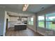 Kitchen features modern appliances, an island with sink, white cabinets, tile backsplash, and ample natural light at 119 Tonbridge Way # Haf0033, Mooresville, NC 28115