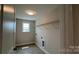 Well-lit laundry room with gray tiled floor and wire rack shelving for efficient storage and organization at 119 Tonbridge Way # Haf0033, Mooresville, NC 28115