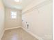 Bright laundry room with tile flooring, a utility sink, and wire shelving for organized storage at 119 Tonbridge Way # Haf0033, Mooresville, NC 28115