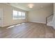 Bright living room with hardwood floors and a big window for natural light at 119 Tonbridge Way # Haf0033, Mooresville, NC 28115