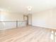 Open loft space with neutral walls, hardwood floors, and railing overlooking the lower level at 119 Tonbridge Way # Haf0033, Mooresville, NC 28115