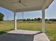 Covered patio features concrete flooring and white pillars, offering a great view of the expansive backyard at 119 Tonbridge Way # Haf0033, Mooresville, NC 28115