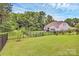 Expansive backyard features lush green grass and a black metal fence, providing privacy and security for outdoor enjoyment at 12014 Belmont Mansion Dr, Charlotte, NC 28273