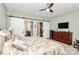 Comfortable bedroom with ceiling fan and barn doors that lead to an en-suite bathroom and walk-in closet at 12014 Belmont Mansion Dr, Charlotte, NC 28273